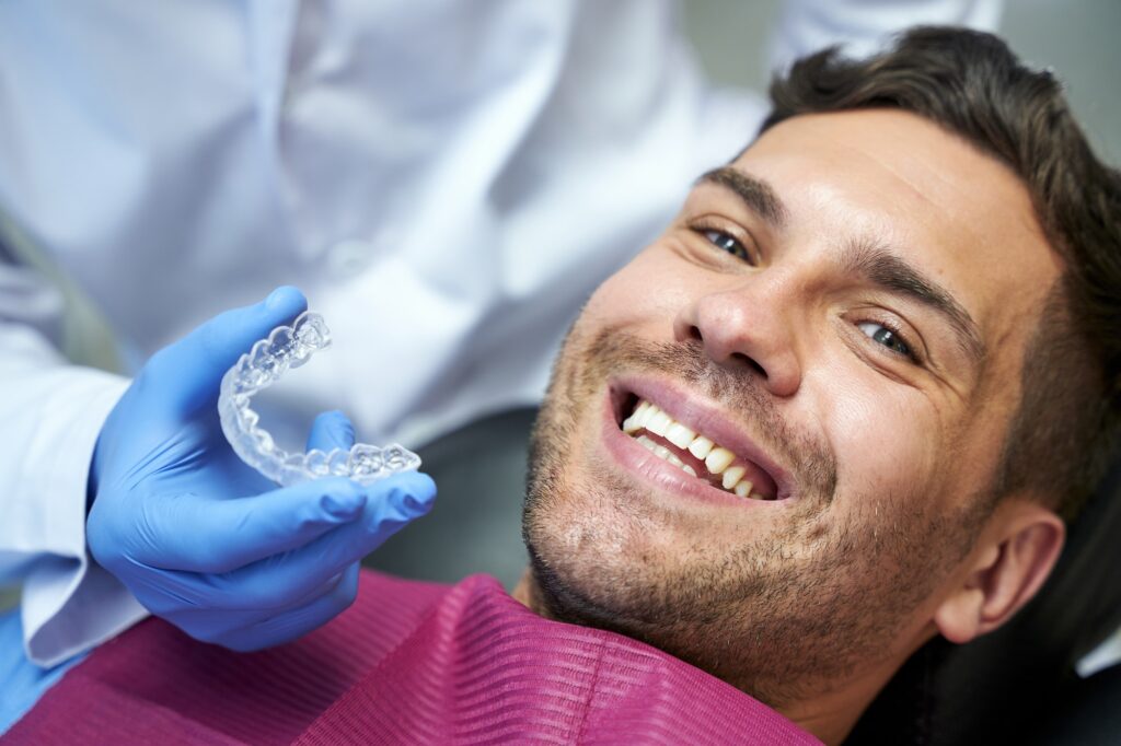 Silicone teeth mold for a young man in dental chair