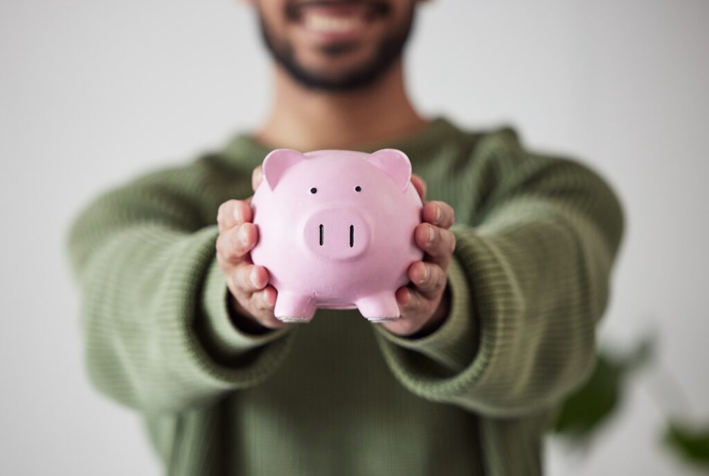 Finance, investment or hands of man with piggy bank for financial wealth growth or savings increase