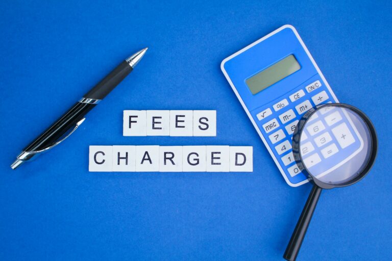 calculator and pen with the word fees charged.