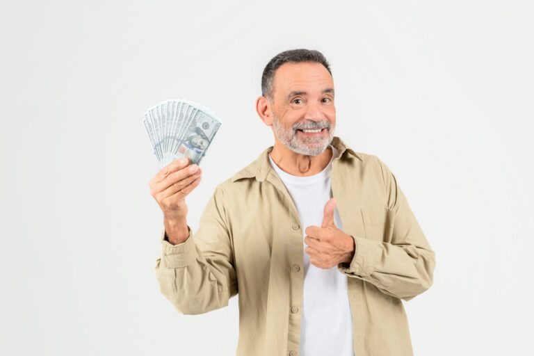 Happy man holding cash and giving thumbs up