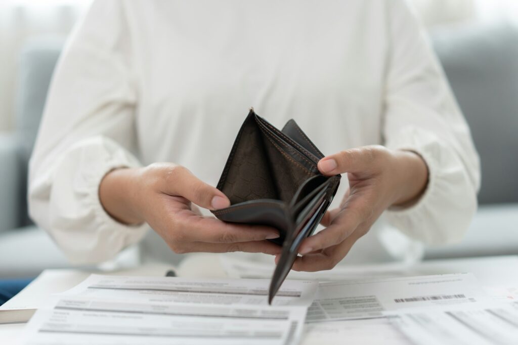 Worried unemployment woman open empty wallet on payday